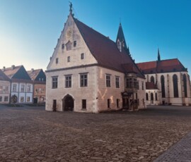 Historická budova v centre mesta, Šuhajovci na cestách, zachytená v krásnom slnečnom dni.